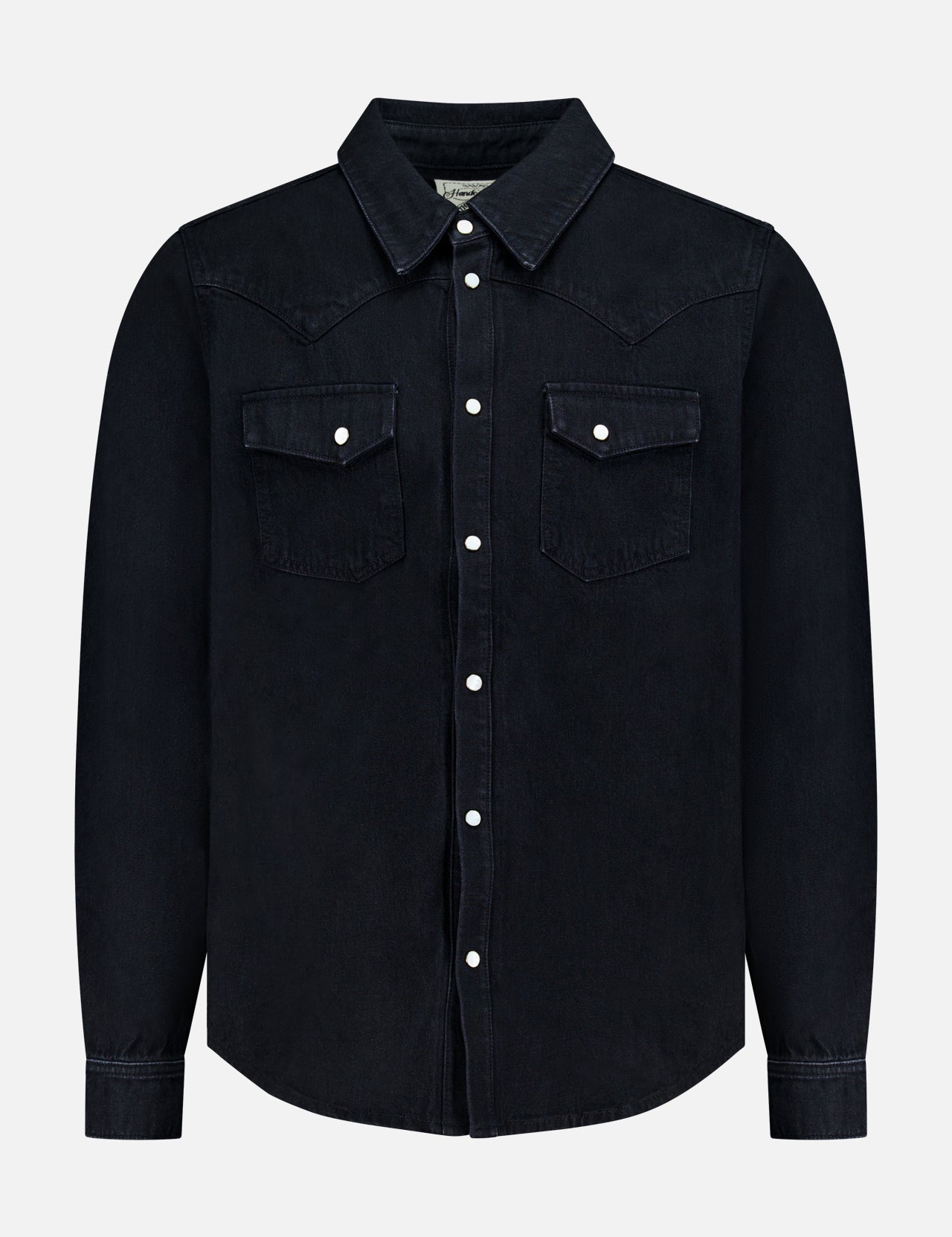 The Allen Denim Shirt by SAVAS is a black, long-sleeve shirt crafted in Los Angeles, featuring white snap buttons and two chest pockets, shown against a plain white background.