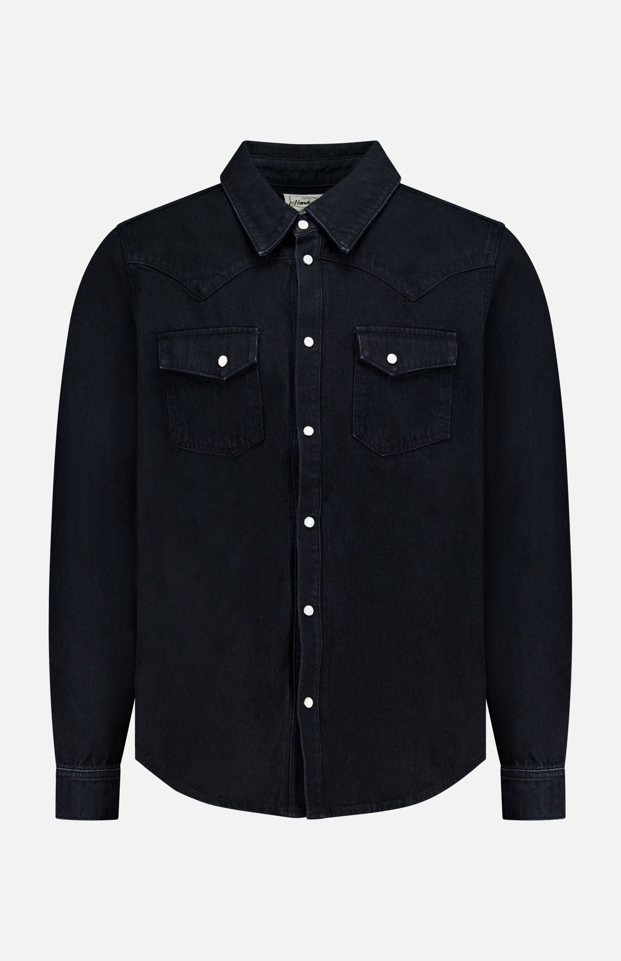 The Allen Denim Shirt by SAVAS is a black, long-sleeve shirt crafted in Los Angeles, featuring white snap buttons and two chest pockets, shown against a plain white background.