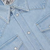 Close-up of a SAVAS Allen Denim Shirt in Japanese selvedge, highlighting snap buttons, two front flap pockets, and a white collar label with text.