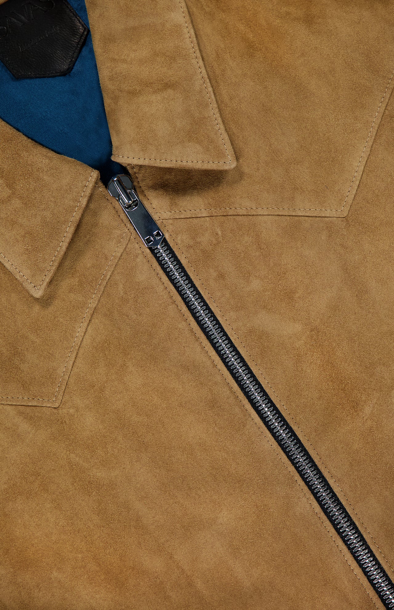 Close-up of the SAVAS Legend Calf Suede Jacket for men, in tan suede, showcasing a silver zipper, pointed collar, and hint of blue lining.