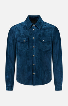Introducing the Lowry Calf Suede Overshirt by SAVAS—a timeless, Italian-made western shirt crafted from luxurious blue calf suede. This long-sleeve overshirt showcases two chest pockets with button flaps, a pointed collar, and silver buttons down the front for a classic finishing touch.