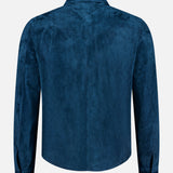 A back view of the SAVAS Lowry Calf Suede Overshirt in deep blue, featuring long sleeves, a pointed collar, buttoned cuffs, and yoke detailing at the shoulders for a classic western-inspired look, displayed against a plain white background.