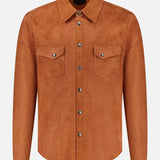 The SAVAS Lowry Lamb Suede Overshirt, crafted in Italy, features a classic collar, long sleeves, and two chest pockets with flap closures and metallic buttons. Inspired by the iconic terracotta western shirt style, this tan overshirt is showcased against a plain white background.