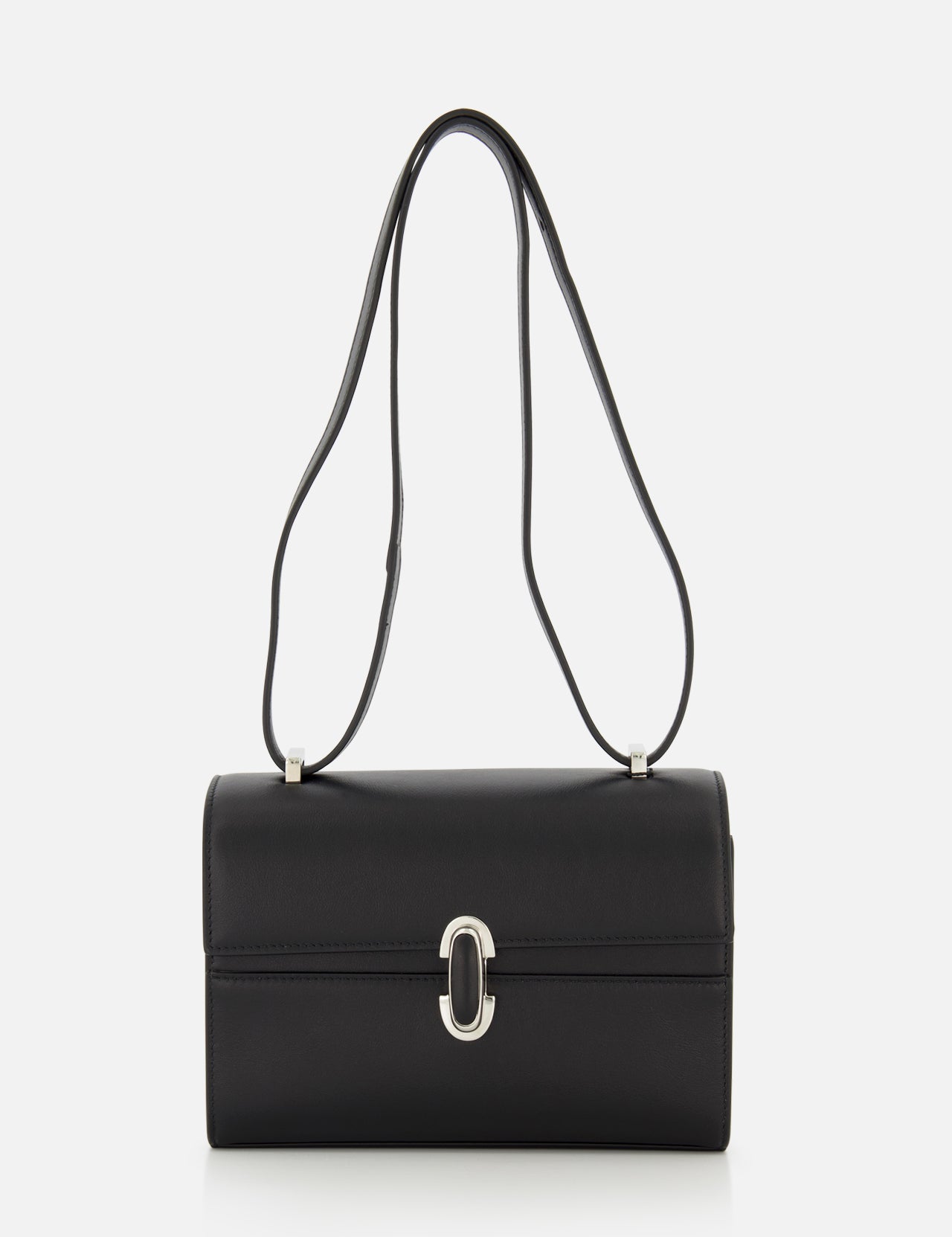The Symmetry 19 Bag by Savette is a black, rectangular Italian handbag with a silver clasp and double handles, displayed against a plain white background. Its smooth, structured silhouette and minimal detailing exude timeless elegance.