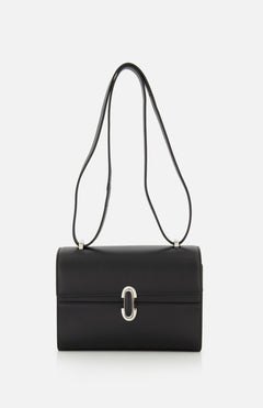 The Symmetry 19 Bag by Savette is a black, rectangular Italian handbag with a silver clasp and double handles, displayed against a plain white background. Its smooth, structured silhouette and minimal detailing exude timeless elegance.