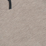 Close-up of the SEASE Drone Hooded Pullover, showcasing its light brown heathered fabric and black-trimmed neckline, viewed from above.
