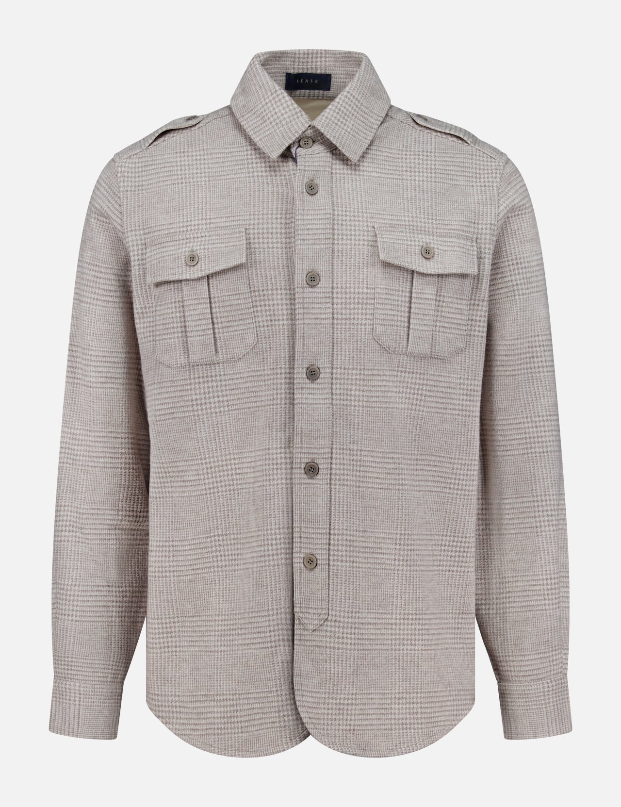The SEASE Glen Plaid Wool Overshirt features a light brown Prince of Wales check, with long sleeves, two flap chest pockets, and shoulder epaulettes. This versatile business travel shirt is shown against a plain white background.