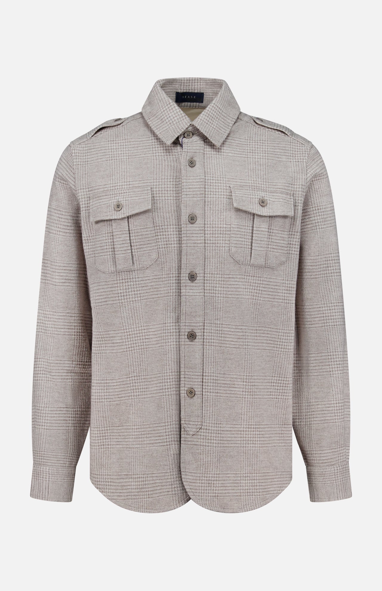 The SEASE Glen Plaid Wool Overshirt features a light brown Prince of Wales check, with long sleeves, two flap chest pockets, and shoulder epaulettes. This versatile business travel shirt is shown against a plain white background.