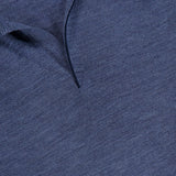 Close-up of the Lasca Long Sleeve Johnny Collar Polo Shirt in blue, showing a partial view of the collar and neck opening. Made from virgin wool, this SEASE piece features a black label with the brand name and size M visible at the top left.