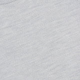 Close-up of the Lasca Long Sleeve Sweater by SEASE, crafted from luxurious Italian knitwear in light grey. This classic crewneck features a visible collar and a dark blue tag displaying the SEASE brand name and size M. The fabric exhibits a smooth, soft texture.