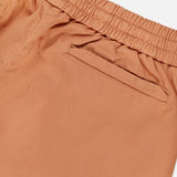 Close-up of SEASE Summer Mindset Drawstring Trouser Pant in pastel tangerine, featuring an elastic waistband and single welt back pocket, set against a white background.