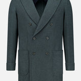 The Double Breasted 180′s Jersey Coat by DORIANI is a dark grey, double-breasted design crafted from luxurious virgin wool and features wide lapels, six buttons, two large front pockets, and folded cuffs. Made in Italy, it is displayed on a plain white background.