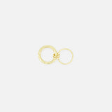 Two yellow gold Agon Vulcan Rings by SPINELLI KILCOLLIN, each in a different size with fluid designs, are interlinked and set against a plain white background.