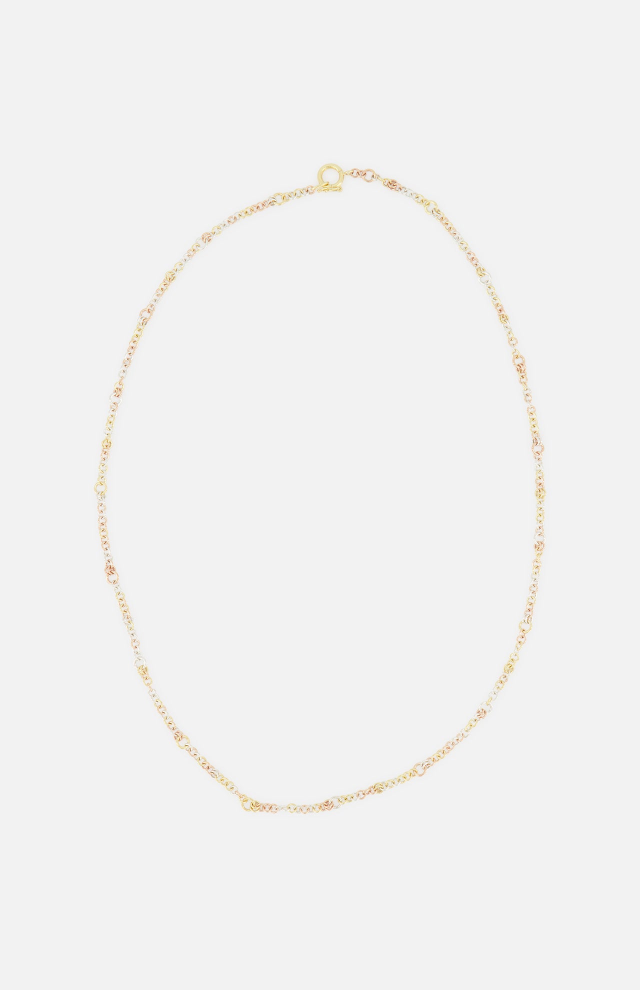The SPINELLI KILCOLLIN Gravity Chain 20" Necklace features fine gold links and a small clasp, elegantly displayed in a loose oval on a white background—ideal for layering or pairing with modular jewelry.