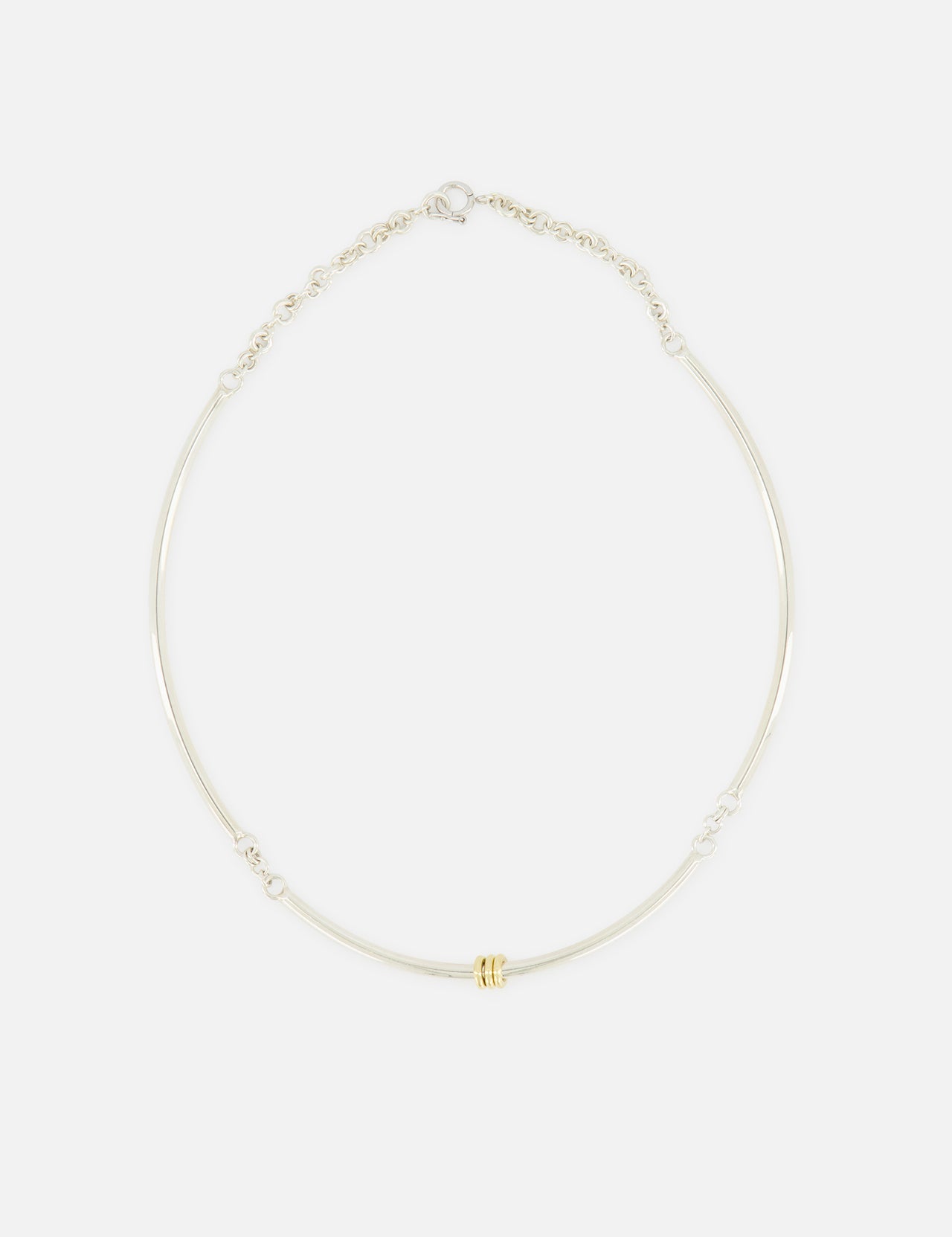 The Hello Tria Silver Necklace by SPINELLI KILCOLLIN features a simple sterling silver chain accented with three gold rings, shown against a plain white background.