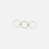 The Libra Gris Diamond Ring by SPINELLI KILCOLLIN features three interlocking rings—two in sterling silver and one in gold—linked together and displayed flat on a white background.