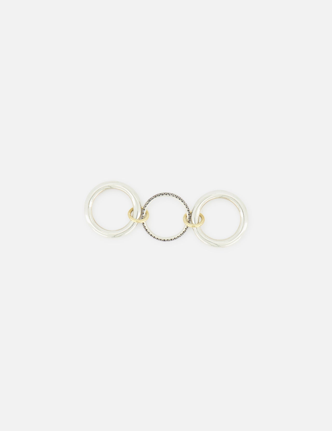 The Libra Gris Diamond Ring by SPINELLI KILCOLLIN features three interlocking rings—two in sterling silver and one in gold—linked together and displayed flat on a white background.
