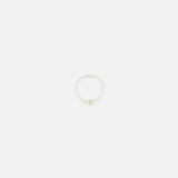 The SPINELLI KILCOLLIN Sirius 3 Annulets Ring is a minimalist unisex sterling silver ring featuring a subtle knot detail, shown against a plain white background.