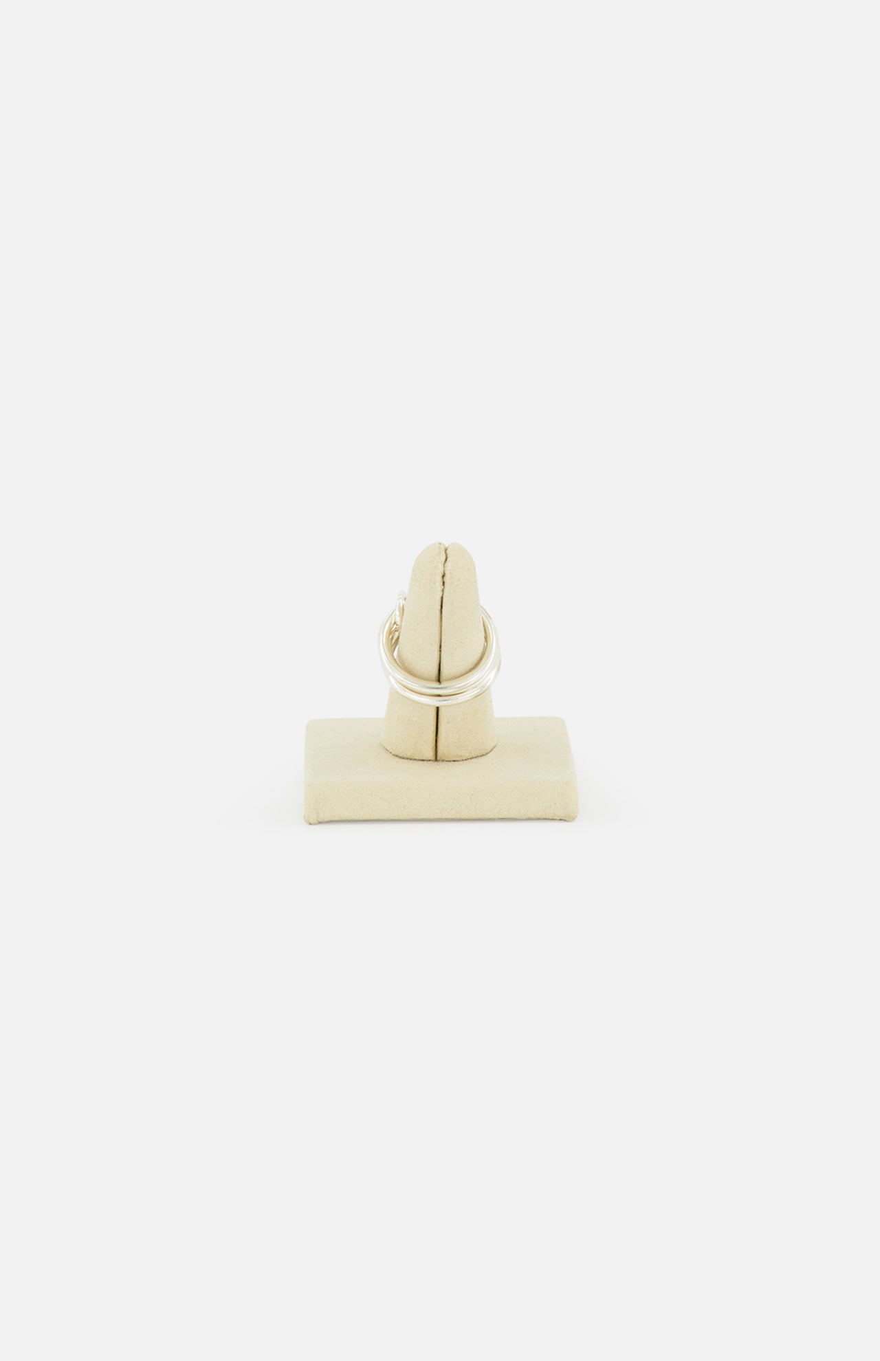 The Jovie Double Pave Ring by SPINELLI KILCOLLIN is shown upright on a beige ring holder against a plain white background, highlighting its elegant sterling silver design.