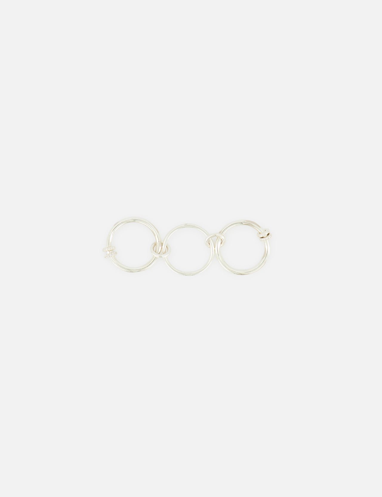 The Jovie Double Pave Ring by SPINELLI KILCOLLIN features interlinked sterling silver bands in a minimalist style, reflecting the brand’s signature elegance against a simple white background.
