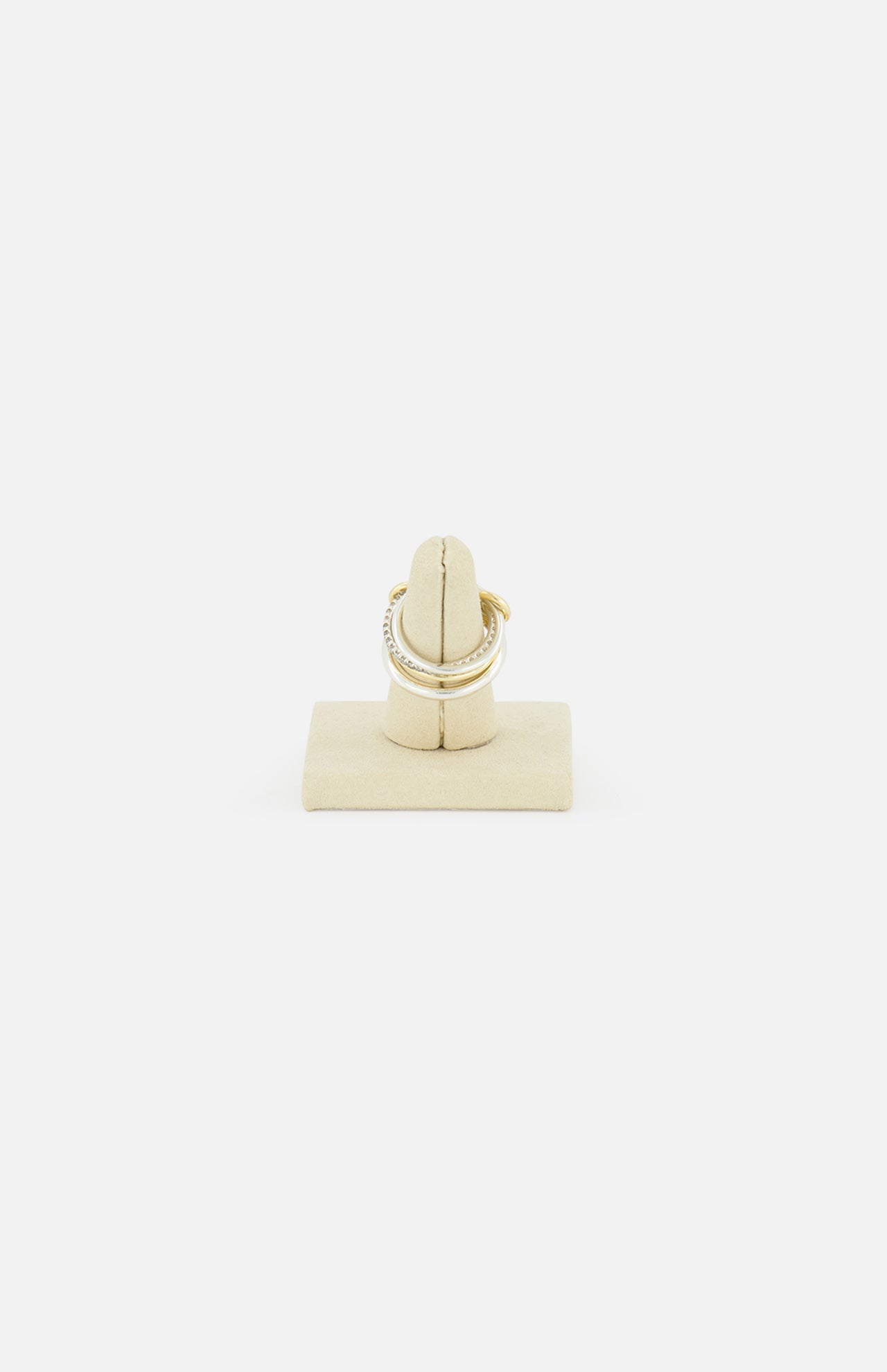 A SPINELLI KILCOLLIN Nimbus 4 Band Diamond Ring featuring small diamonds, shown on a beige ring holder against a plain white background.