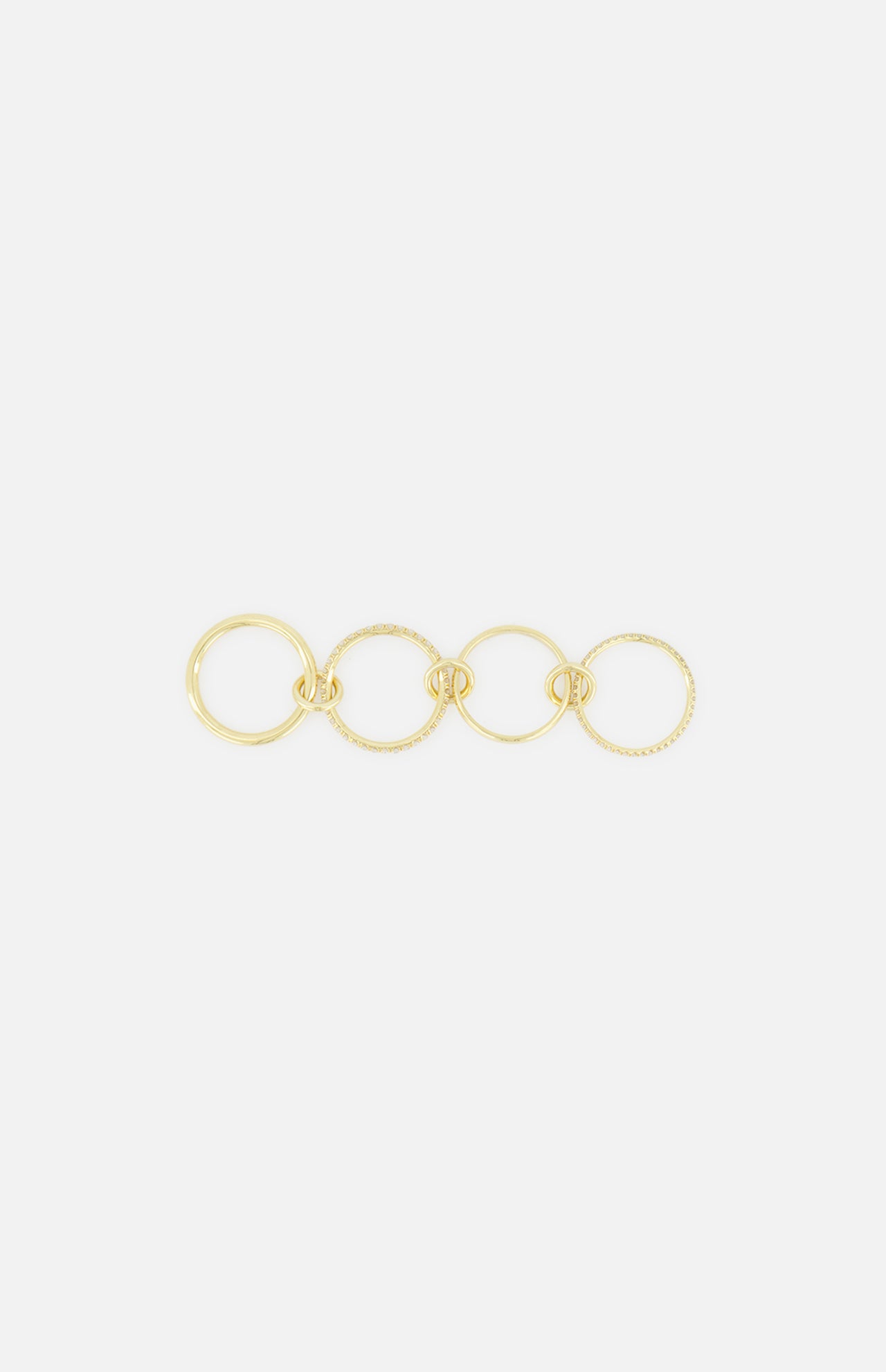 The Polaris 4 Band Ring by SPINELLI KILCOLLIN features four elegantly linked gold bands of varying sizes, arranged in a straight line against a plain white background.