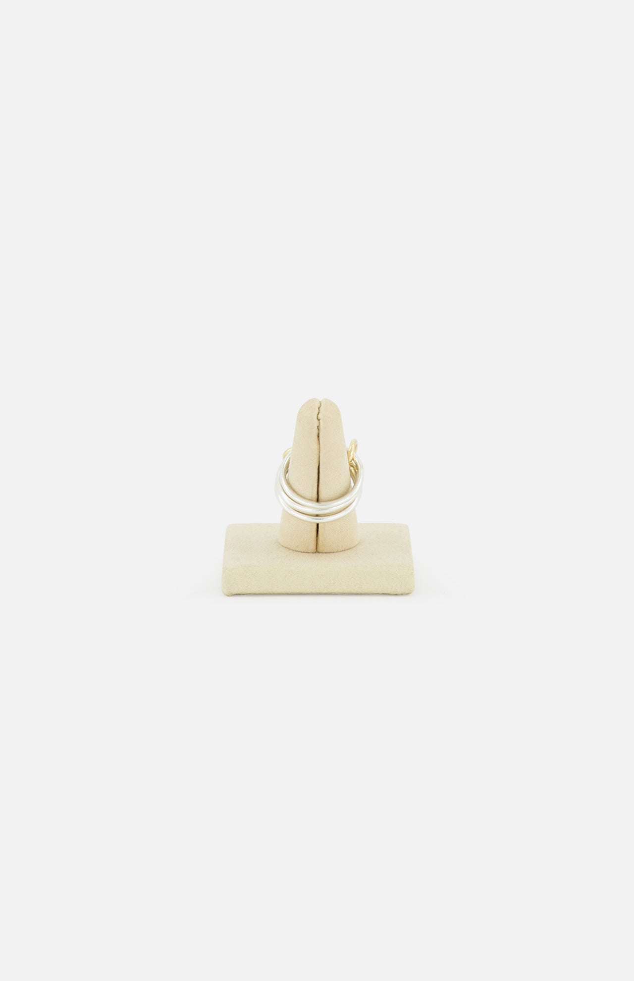The Raneth 3 Band Ring by SPINELLI KILCOLLIN, crafted in sterling silver, is shown on a beige padded ring holder against a plain white background.