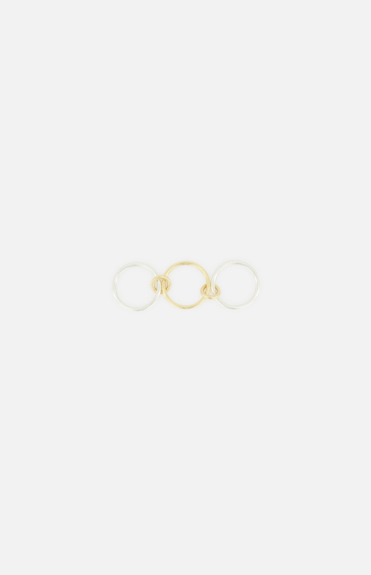The Solarium 3 Band Ring by SPINELLI KILCOLLIN features three interlocking bands—a yellow gold center band flanked by two sterling silver bands—shown on a plain white background.
