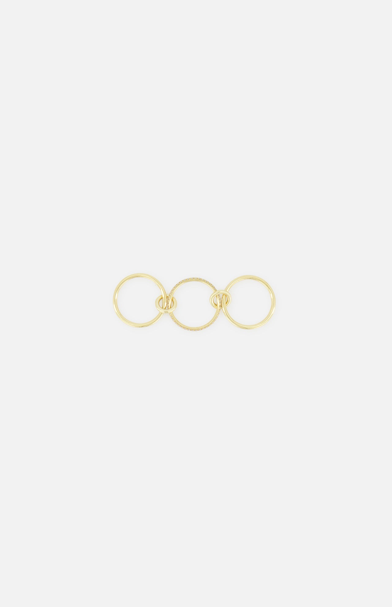 The SPINELLI KILCOLLIN Sonny Pavé Band Ring, crafted in yellow gold with three interlocking circles connected by decorative knots, is shown against a plain white background.