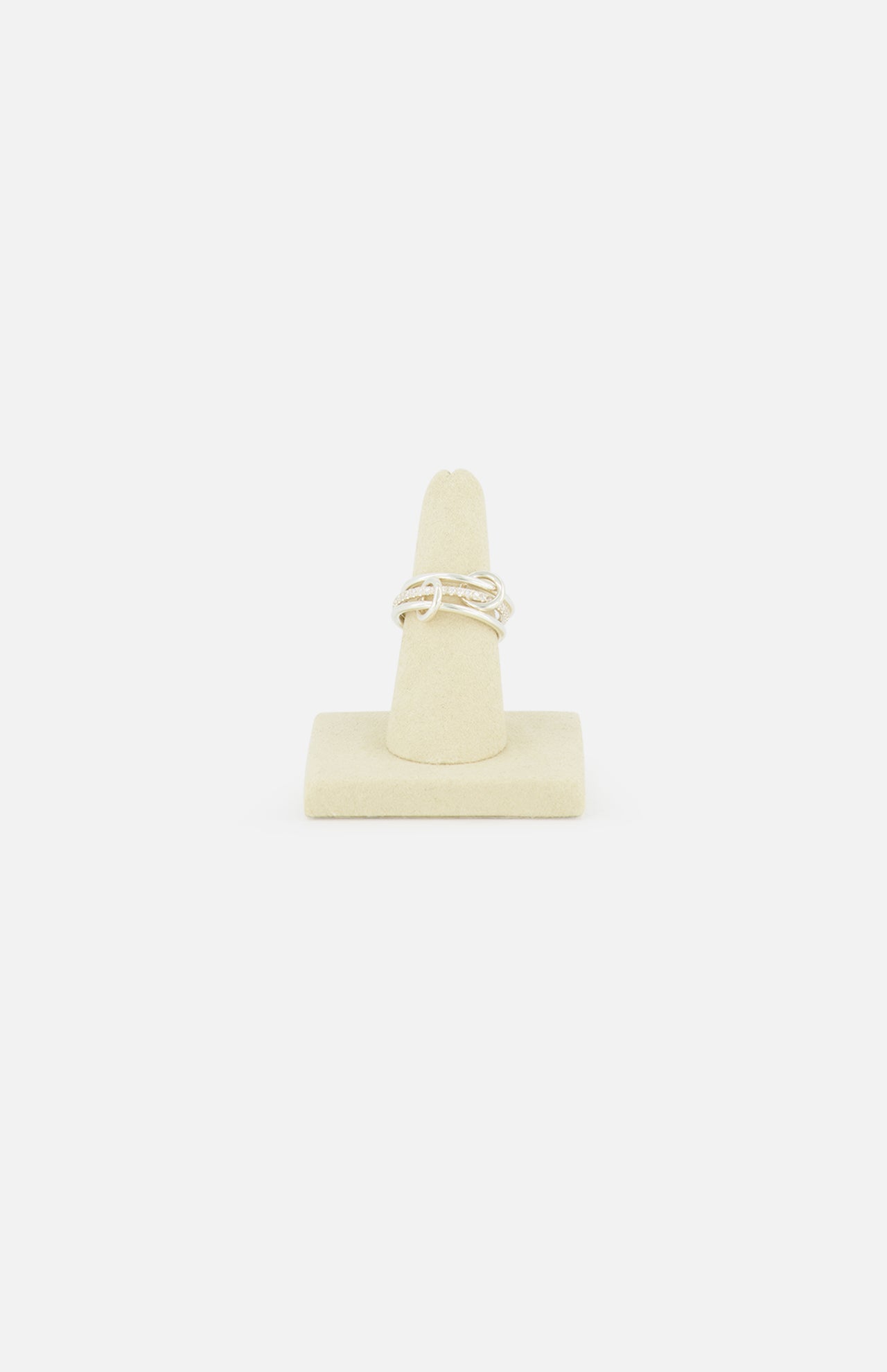 The SPINELLI KILCOLLIN Sonny Pavé Band Ring in sterling silver is shown upright on a beige ring holder, set against a plain white background.