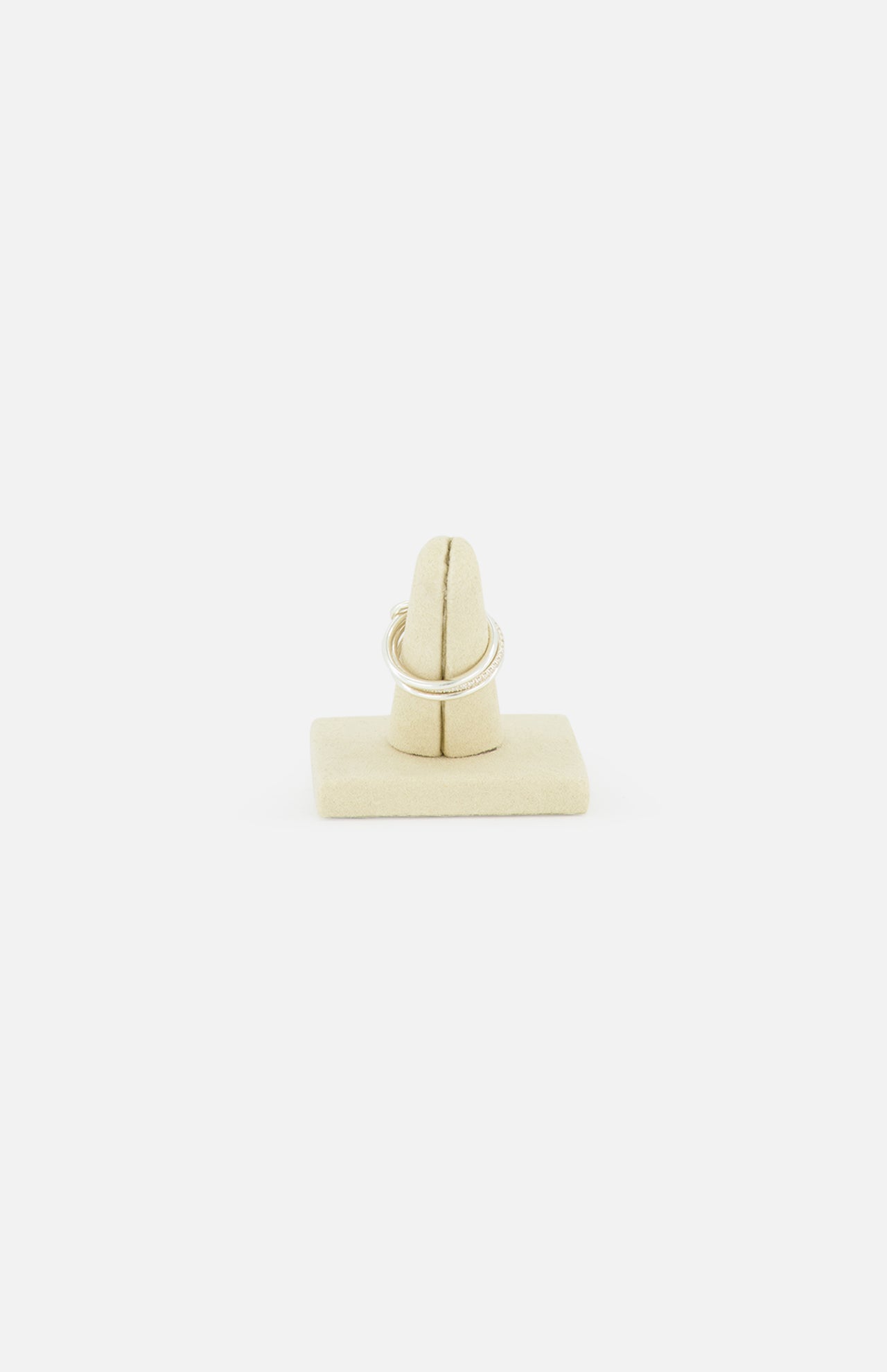 The SPINELLI KILCOLLIN Sonny Pavé Band Ring is shown upright on a beige velvet ring stand, with a plain white background.