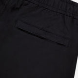Close-up of the back of STONE ISLAND Drawstring Cargo Trouser Pant in black, featuring an elastic waistband and single welt pocket—a sleek streetwear essential.