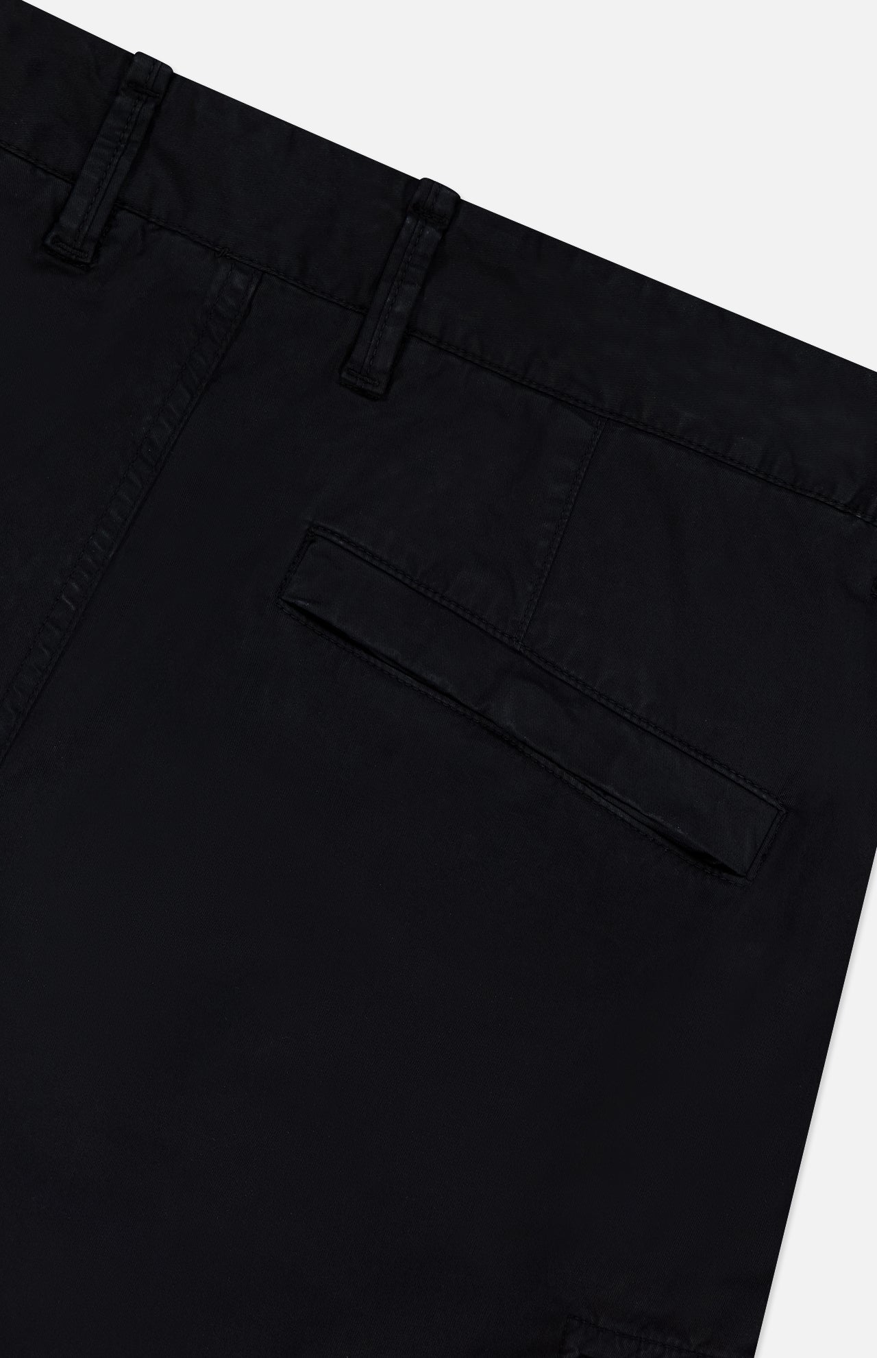 Close-up of the STONE ISLAND Cotton Stretch Cargo Trouser Pants in black, highlighting the waistband, belt loops, and a single flap back pocket against a plain white background—an essential addition to any streetwear collection.