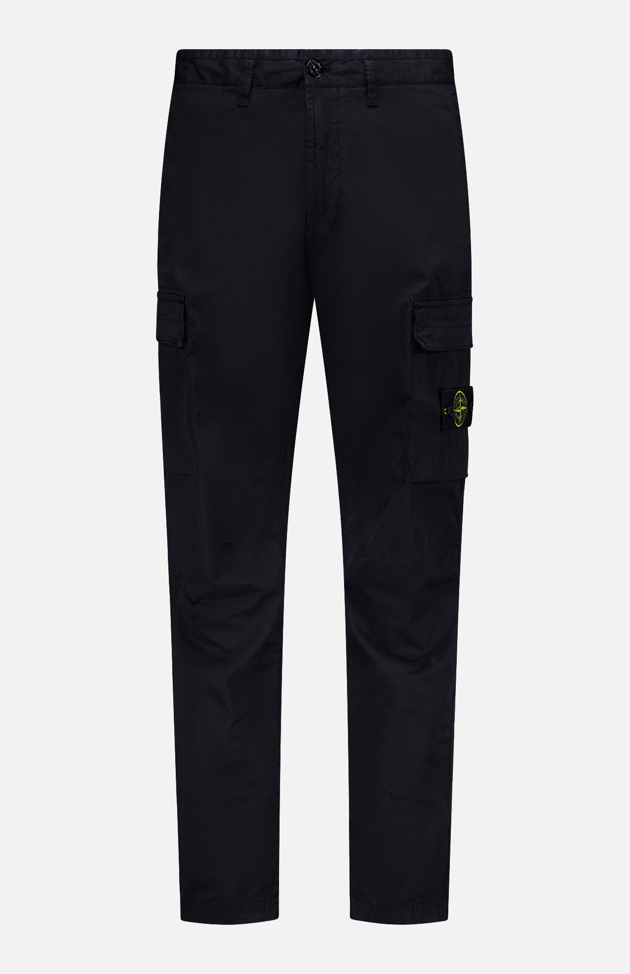 STONE ISLAND Cotton Stretch Cargo Trouser Pants in black, featuring side pockets and a button closure. A yellow and green circular Stone Island logo patch accents one pocket. These streetwear-inspired cargo pants are showcased against a plain white background.