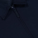 Close-up of the Coach Full Zip Jacket by STONE ISLAND in navy blue, highlighting the collar, zipper, and part of the fleece inner lining. This wool-cotton jacket features a small black tag with visible text near the collar.
