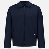 Coach Full Zip Jacket by STONE ISLAND in navy blue, featuring a zip-up front, collared neckline, two buttoned front pockets, and signature patch on the left sleeve. Crafted from a premium wool-cotton blend sportswear fabric and showcased against a plain white background.