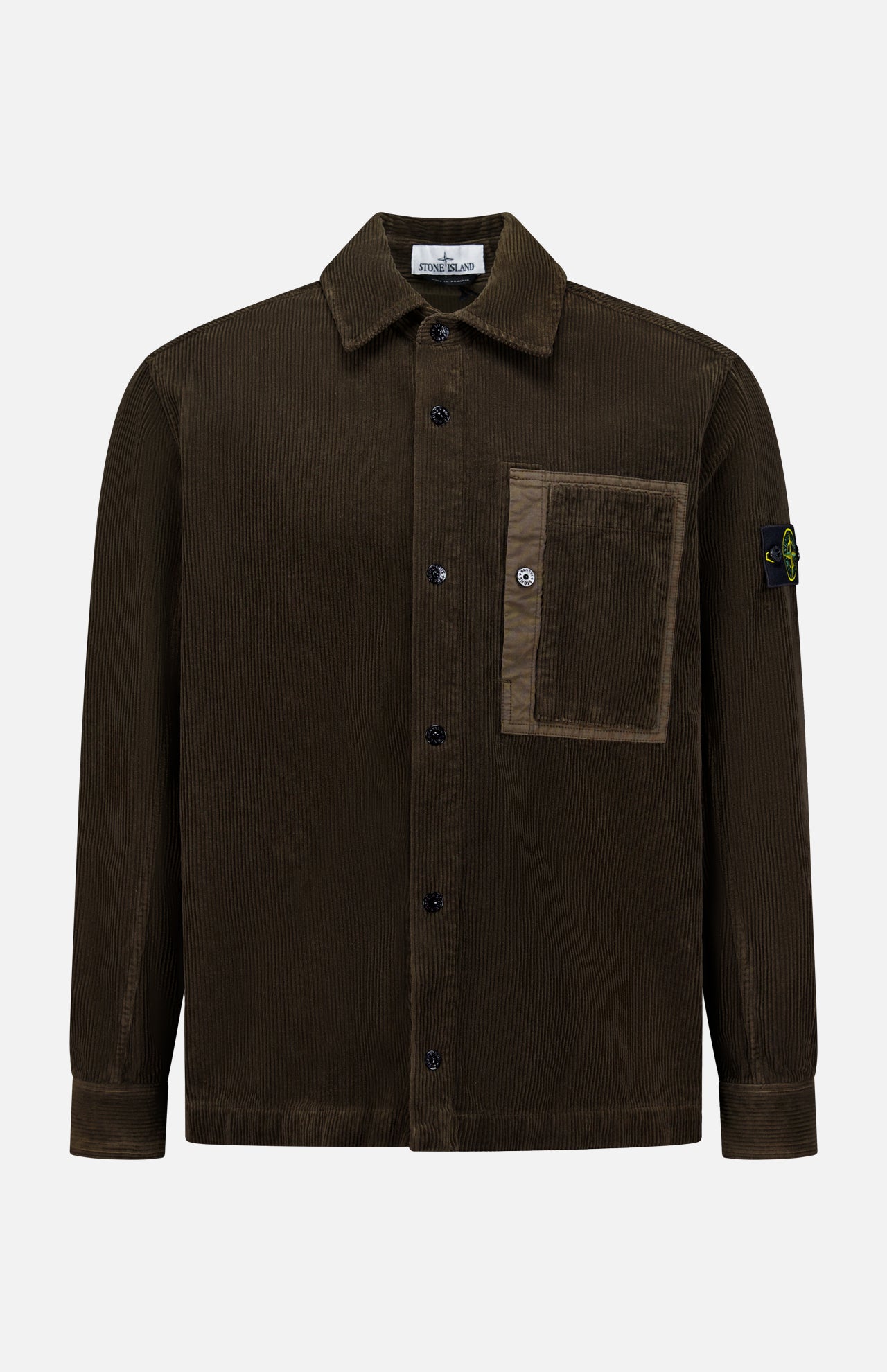 The STONE ISLAND Corduroy Chest Pocket Overshirt in brown features a front chest pocket, collar, and the iconic black patch with yellow and green compass logo on the left sleeve—an essential men's sportswear piece.