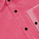 Close-up of the STONE ISLAND Corduroy Chest Pocket Overshirt in pink, featuring black buttons, a collar, and a flap chest pocket. The corduroy's vertical ridges enhance its streetwear style.