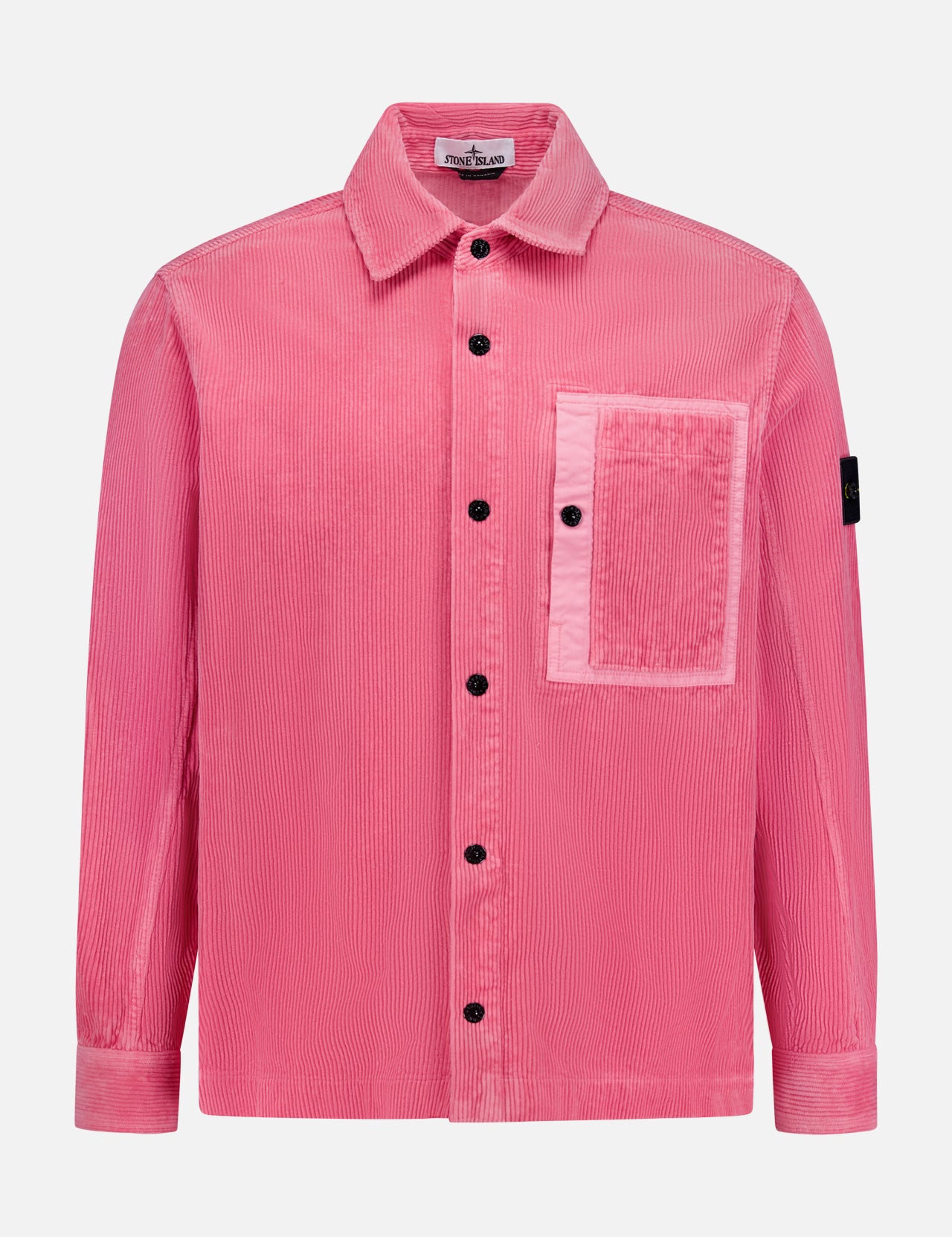 The STONE ISLAND Corduroy Chest Pocket Overshirt is a pink, long-sleeve button-up with a large chest pocket and black sleeve patch, inspired by classic overshirt style. Shown on a white background and perfect for streetwear.