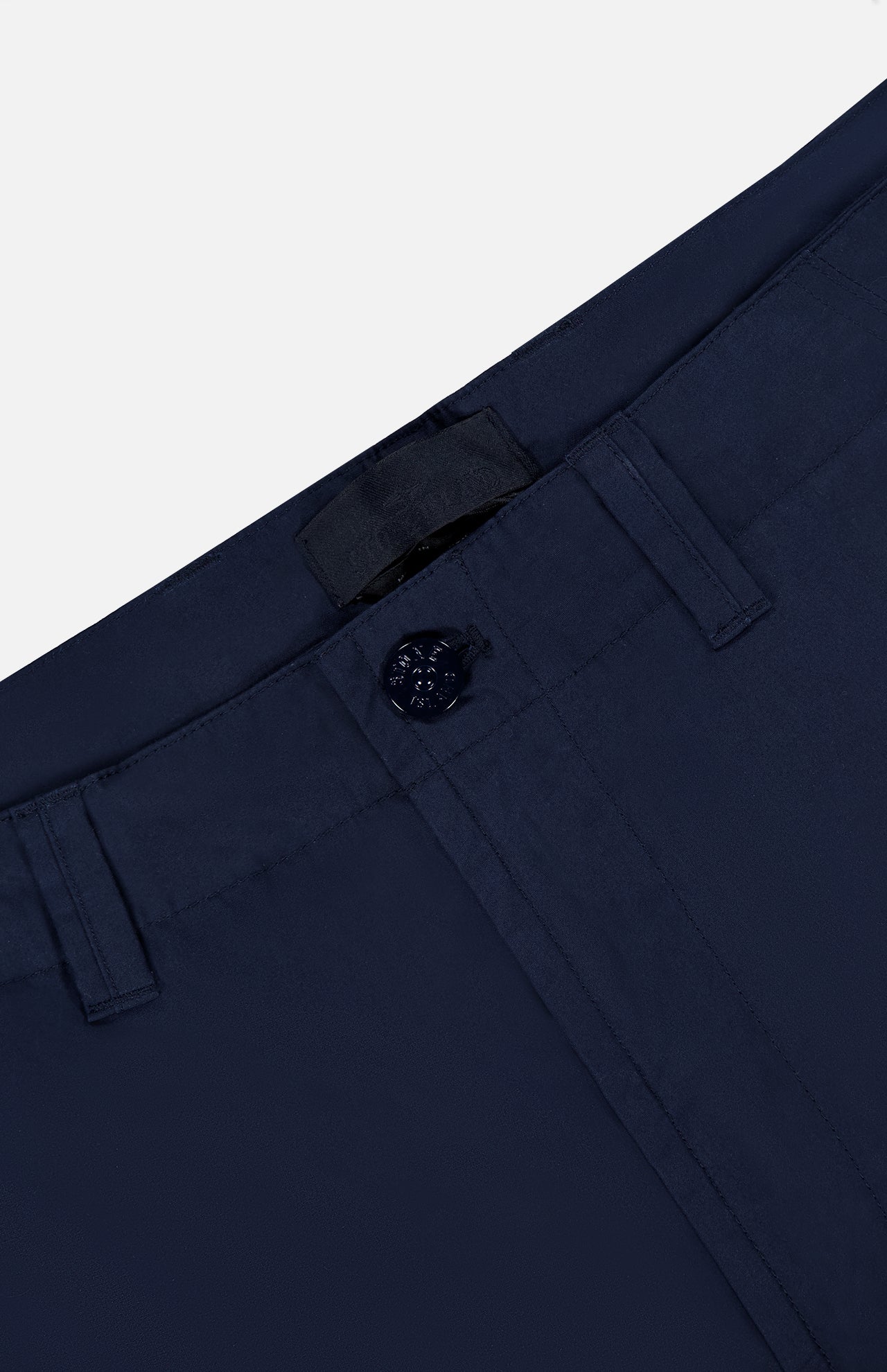 Close-up of the waistband and upper front of STONE ISLAND Ghost Cargo Trouser Pants in navy, featuring button closure, belt loops, and precise stitching, all set against a light background.