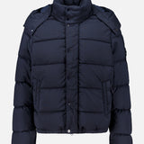 Dark navy Stone Island Ghost Hooded Puffer Jacket featuring a high collar, detachable hood, and snap-button front closure.