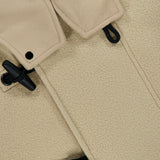 Close-up of the STONE ISLAND Hooded Toggle Jacket in beige, crafted from a textured wool-cashmere blend. The jacket features black toggle buttons threaded through black cord fastenings and is finished with a soft collar. The thick fabric gives it a warm, substantial feel.