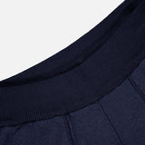 Close-up of STONE ISLAND Knitwear Drawstring Shorts in navy, featuring a ribbed waistband and vertical stitched seams on soft cotton-blend fabric.