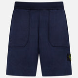 STONE ISLAND Knitwear Drawstring Shorts in navy cotton-blend feature an elastic waistband, front patch pockets, and a black and yellow logo patch on the left leg. Displayed against a plain white background.