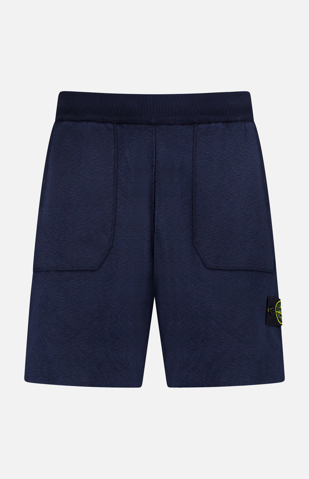 STONE ISLAND Knitwear Drawstring Shorts in navy cotton-blend feature an elastic waistband, front patch pockets, and a black and yellow logo patch on the left leg. Displayed against a plain white background.