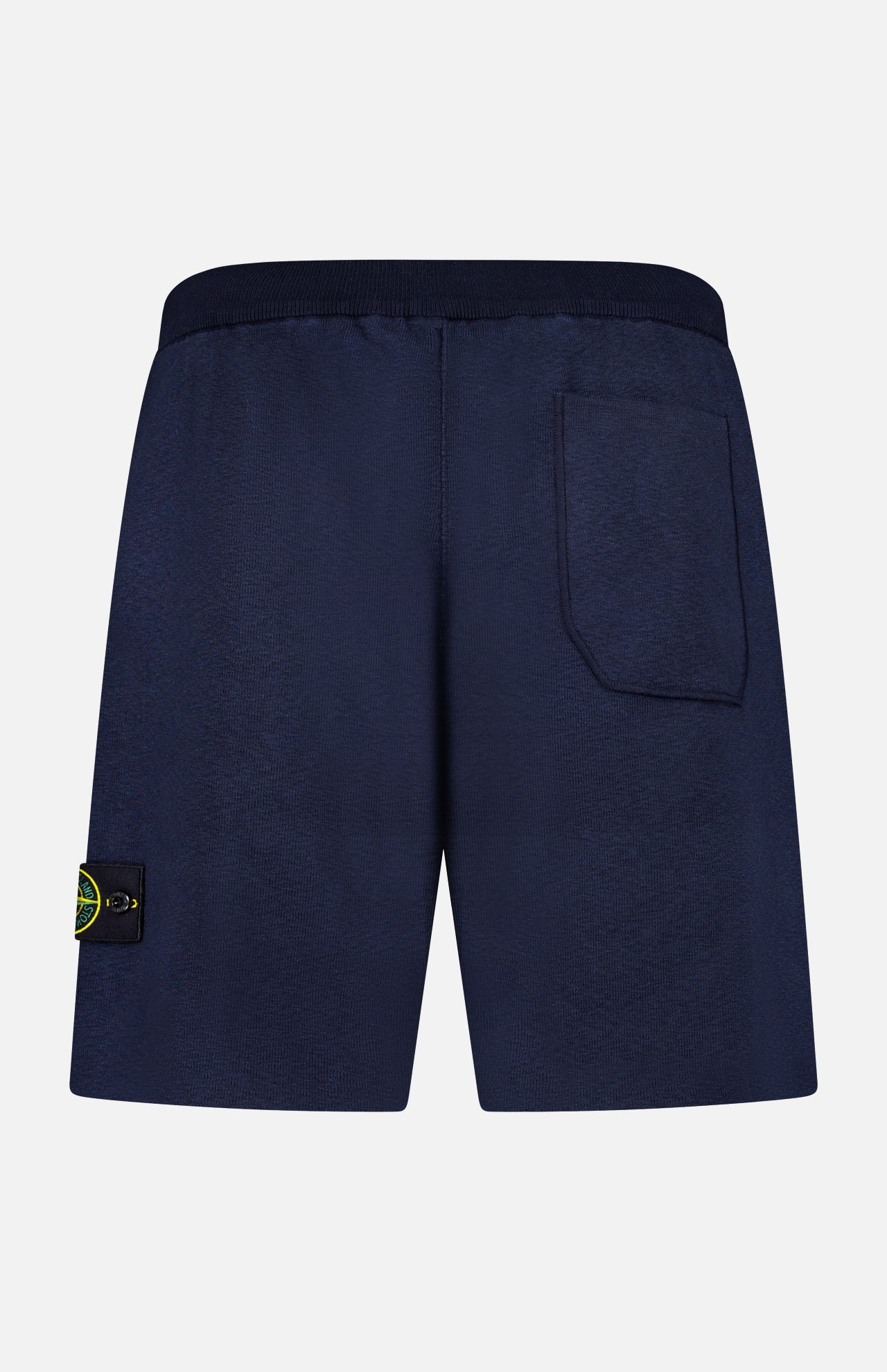 STONE ISLAND Knitwear Drawstring Shorts in navy, shown from the back with a right-side back pocket and a yellow-green logo patch on the left leg, made from a soft cotton-blend fabric.