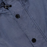 Close-up of the STONE ISLAND Long Waxed Coating Parka Coat in navy, showing two black buttons, a drawstring hood with black toggles, and highlighting its technical fabric texture and stitching details.