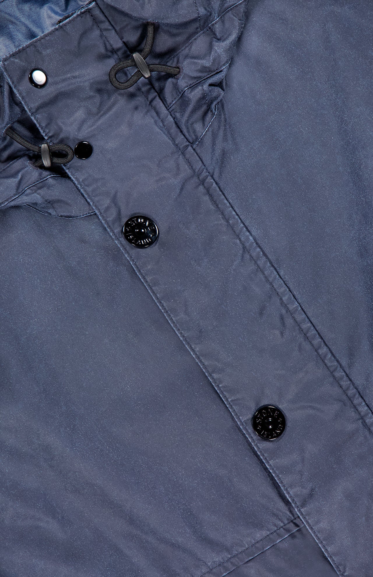 Close-up of the STONE ISLAND Long Waxed Coating Parka Coat in navy, showing two black buttons, a drawstring hood with black toggles, and highlighting its technical fabric texture and stitching details.