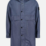 The STONE ISLAND Long Waxed Coating Parka Coat is a navy spring jacket with a hood, inspired by the brand’s technical parka designs.