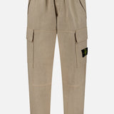 The Loose-Fit Cargo Jogger Pant by STONE ISLAND comes in beige with an elastic waistband and cuffs, side pockets, and spacious cargo pockets on the thighs. A black and yellow logo patch accents one pocket, giving these pants a bold yet versatile jogger-inspired style.